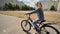 A twelve-year-old girl riding her bike on a warm summer day.