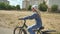 A twelve-year-old girl riding her bike on a warm summer day.