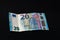 Twenty memorable euros lie on a black background