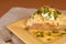 A twice baked potato with scallions, cheese and sour cream