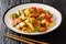 Twice cooked pork is Szechuan style stir-fry pork belly cooked in sauce and vegetables closeup in the plate. Horizontal