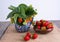 Twigs with strawberries in a ceramic vase and in a wooden bowl strawberries, a few strawberries lie side by side