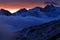 Twilight in the mountain. Foggy morning in Italian Alps, early morning in the mountain with snow during violet twilight, hills in