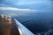 Twilight over a cruise ship deck, sailing across the calm ocean