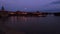 Twilight panorama of Smetana riverbank with National Theater in Prague with traffic and reflection in Vlatava river.