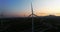 Twilight\'s embrace: captivating aerial journey through wind turbines