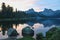 Twilight on Shore of large mountain lake Svetloye, surrounded by coniferous forest in Ergaki. Summer landscape