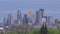 A twilight shot of the Minneapolis skyline rising above a green tree line