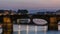 Twilight sky scene of Ponte Santa Trinita Holy Trinity Bridge day to night timelapse over River Arno