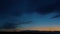 Twilight sky after sunset. Young month against the blue sky. The smooth movement of the clouds. Time lapse.