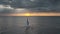 Twilight sunset over travelers on sailboat at open sea aerial. Nature seascape. Water transport
