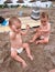 Twin babies playing in the sun-beach time