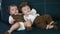 twin babies in retro clothes. brother and sister a twins kids sit on the couch in retro clothes cap play among