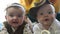 twin babies in retro clothes. brother and sister a twins kids sit on the couch in retro clothes cap play among