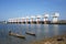 Twin boats float on the river and dam