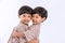 Twin boys hugging  on white background. Portrait of little son hugging brother or friend. I missing you. Full length happy boy emb