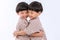 Twin boys hugging  on white background. Portrait of little son hugging brother or friend. I missing you. Full length happy boy emb