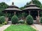 Twin brown wooden gazebos in city park