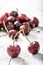 Twin cherries on a wooden table and a bunch of fresh cherries in the background