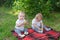 Twin children eat apples in fresh air sitting