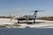 Twin engine aircraft with turboprop power plant under snow in sunny winter day