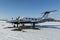 Twin engine aircraft with turboprop power plant under snow in sunny winter day