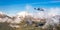 Twin Engine Airplane Flying over the Rocky Mountain Landscape.