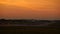 Twin engine turboprop airplane landing at sunrise