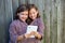 Twin girls dressed up pretending be siamese and tablet pc