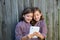 Twin girls dressed up pretending be siamese and tablet pc