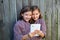 Twin girls dressed up pretending be siamese and tablet pc