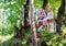 Twin girls resting and sitting on bench in woods.