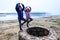 Twin girls standing on remains of ancient roman water well