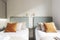 Twin headboards of youthful beds upholstered in gold