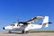 Twin propeller airplane on a runway.