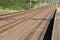 Twin Rail Tracks Leading Through Rural Railway Station