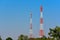 Twin red- white Telephone Signal tower which has a wireless telephone transceiver and amplifies the signal of the 4g or 5g telepho