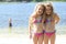 Twin sisters in bathing suits at the lake