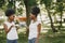 Twin sisters holding a cups with drinks and looking on each other