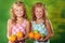 Twin sisters holding fruits