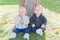 Twin Toddlers Sitting Near Tree Trunk