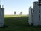 Twin white Adirondack chairs on sunny lawn inside