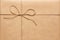 Twine bow on kraft wrapping paper background