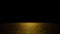 Twinkling golden glitter on a flat surface lit by a bright spotlight on black background