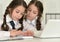 Twins girls using digital devices