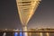 Twisted Bridge. Structure of architecture with lake or river, Dubai Downtown skyline, United Arab Emirates or UAE. Financial