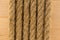 Twisted brown rope on background of the board