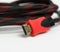 Twisted cable in a textile black sheath on a white background, hdmi adapter