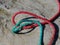 Twisted nylon green and red ropes. Detail of old used rope