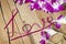 Twisted ribbon word Love on wood with orchids